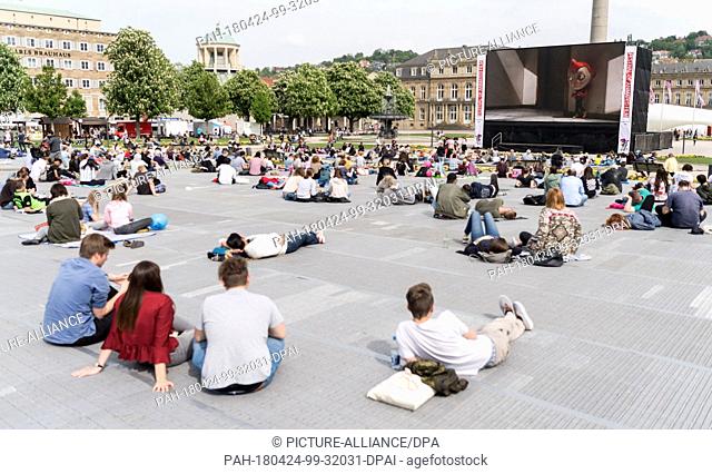 24 April 2018, Germany, Stuttgart: Visitors watching ""My Life as a Courgette, "" the first film running on the open-air stage of the International Festival of...