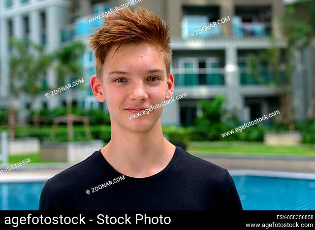 Portrait of young handsome teenage boy outdoors