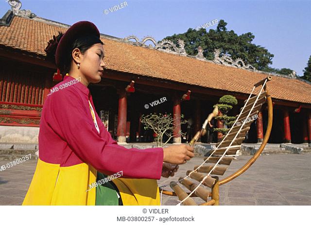 Vietnam, Hanoi, Van Mieu 'literature temples', Woman, Lithophone play, on the side Asia, southeast Asia, temples, natives, Vietnamese, Clothing