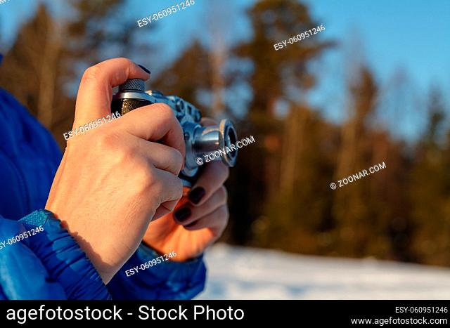 Outdoor amateur photography concept, vintage camera in hands