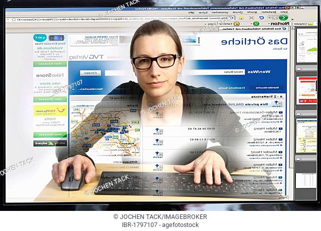 Young woman sitting at a computer surfing the Internet, viewing a page to search for telephone numbers, Das Oertliche, view from within the computer
