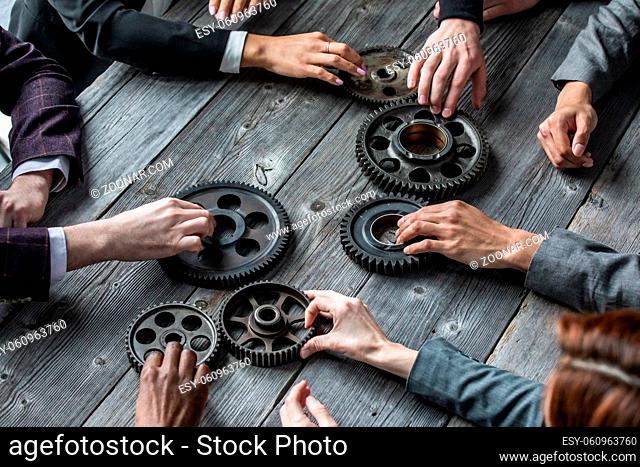 People with gear cogs of business teamwork cooperation concept