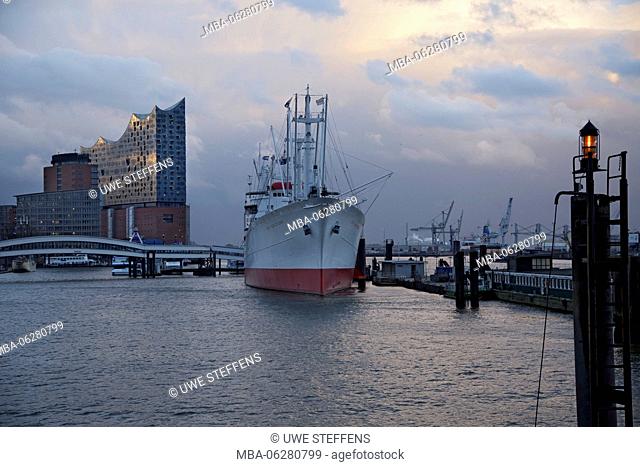 Cap San Diego in front of the Hanse-Trade-Center and the Elbphilharmonie / Elbe Philharmonic Hall in the light of a shower of rain in the evening