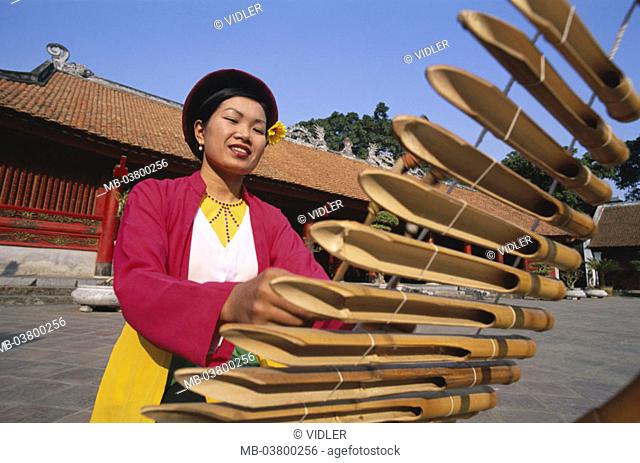 Vietnam, Hanoi, Van Mieu 'literature temples', Woman, Lithophone play Asia, southeast Asia, temples, natives, Vietnamese, Clothing, makes music traditionally