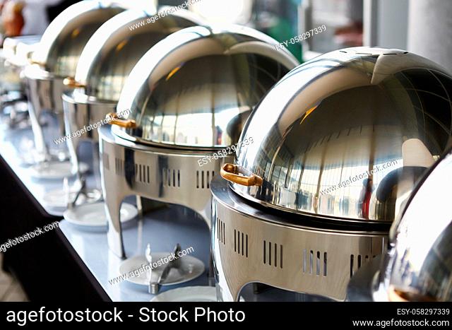 The buffet Table with Row of Food Service Steam Pans