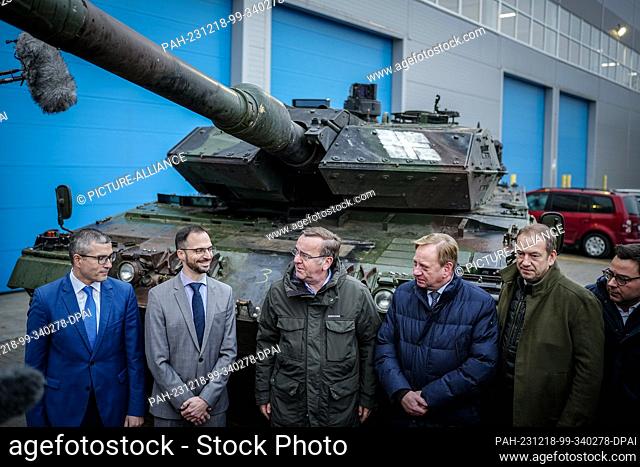 18 December 2023, Lithuania, Jonava: Boris Pistorius (M, SPD), Federal Minister of Defense, stands in front of a Leopard 2 tank from Ukraine at the Lithuanian...