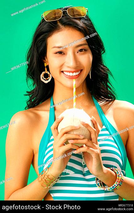 For the swimsuit beauty portrait drink coconut juice