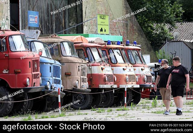 06 July 2021, Mecklenburg-Western Pomerania, Ribnitz-Damgarten: Former GDR trucks of the type ""Robur"" and ""W50"" stand in front of an exhibition hall in the...
