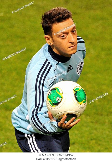 German national soccer player Mesut Oezil catches the ball during the final training before the match against Sweden at Friends Arena Solna in Stockholm