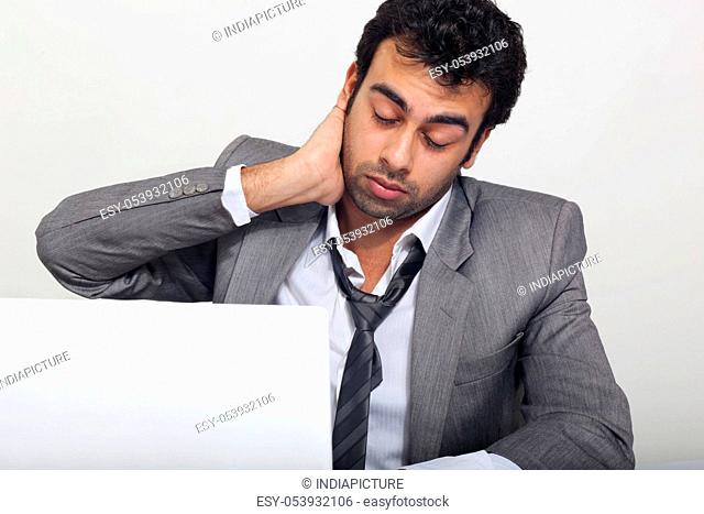 Businessman feeling tired at work