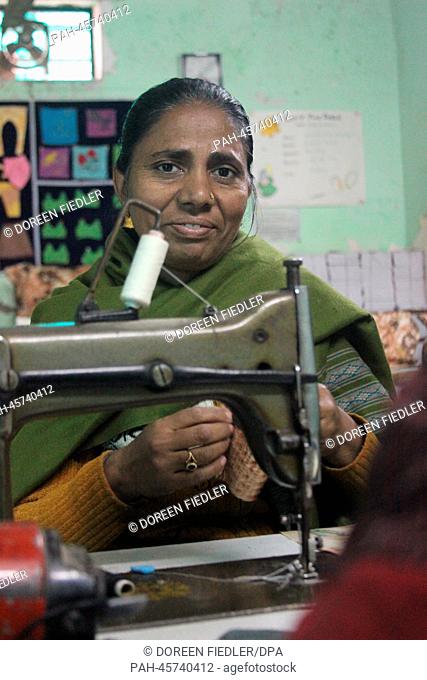 Indian Nazma works on a sewing machine in the leper colony 'Village of Hope' in Delhi, India, 22 January 2014. The 38-year-old was healed