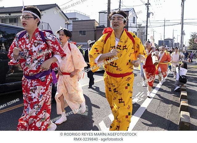 February 24, 2019, Tokyo, Japan - Participants dressed in women's kimonos and wearing makeup, run from house to house to chase away evil spirits during the...