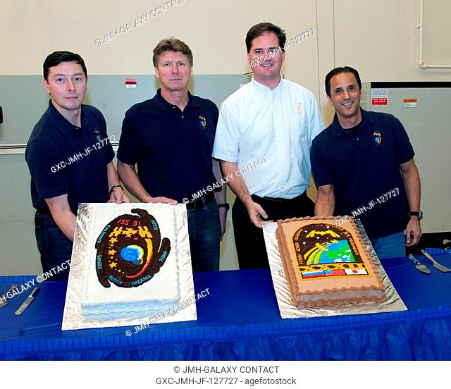 Expedition 3132 crew members, along with Joshua Matthew, pose for a photo during a cake-cutting ceremony in the Jake Garn Simulation and Training Facility at...