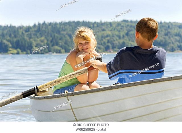 Boy and girl in row boat