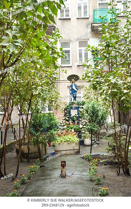Shrine in courtyard of apartment building, left over from war, Praga district, Warsaw, Poland, Europe