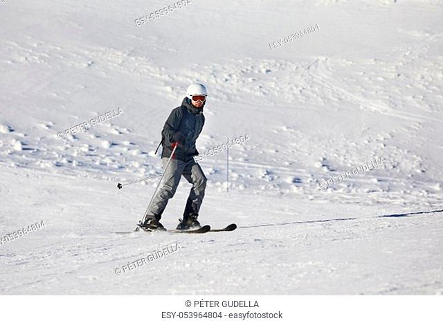 Skiers sliding down a snowy slope