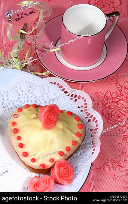 Small heart-shaped cake, marzipan roses, pink cup & saucer