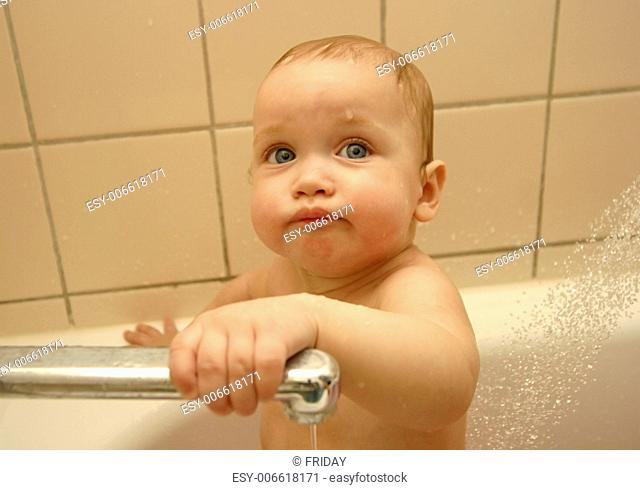 The little child taking a bath