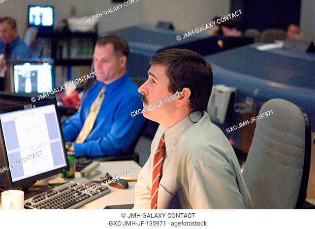 STS-122 lead shuttle flight director Mike Sarafin monitors docking activities between Space Shuttle Atlantis and the International Space Station at his console...