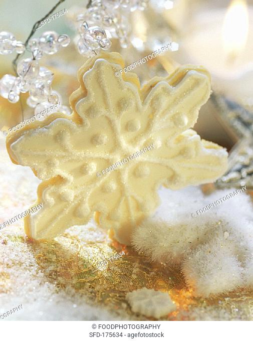 A star-shaped vanilla biscuit with orange and lemon icing