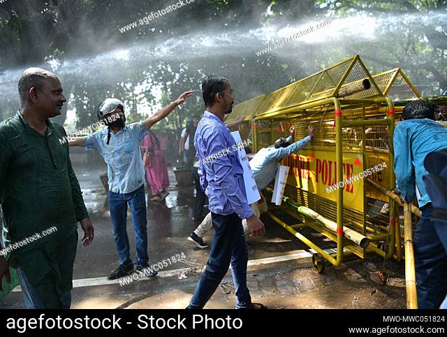 Police personnel use water cannons to disperse terminated school teachers during a protest in Agartala. Tripura, India