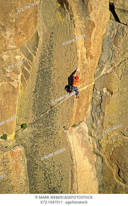 Man rock climbing a route called Strategic Defense which is rated 5, 11 and located on Morning Glory Spire at The City Of Rocks National Reserve in southern...