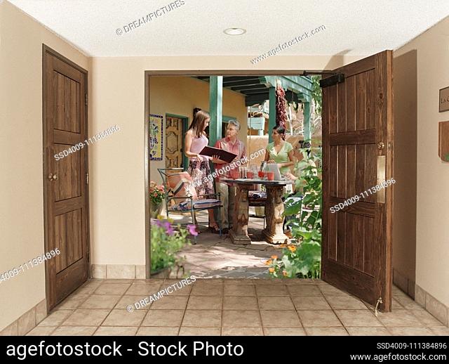 View through doorway to multi-ethnic women on patio