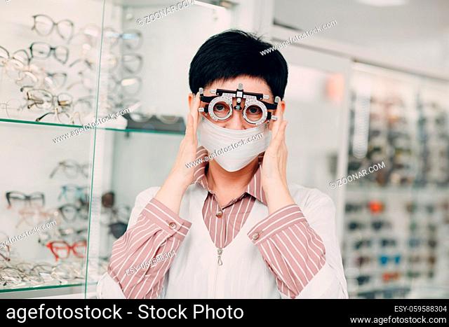 Portrait of an optometrist ophthalmologist middle aged adult woman wearing protective medical face mask