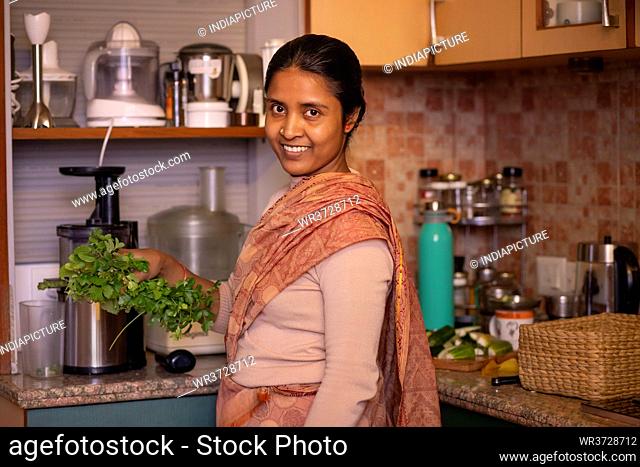 Young lady gets ready to make fresh juice using her garden produce