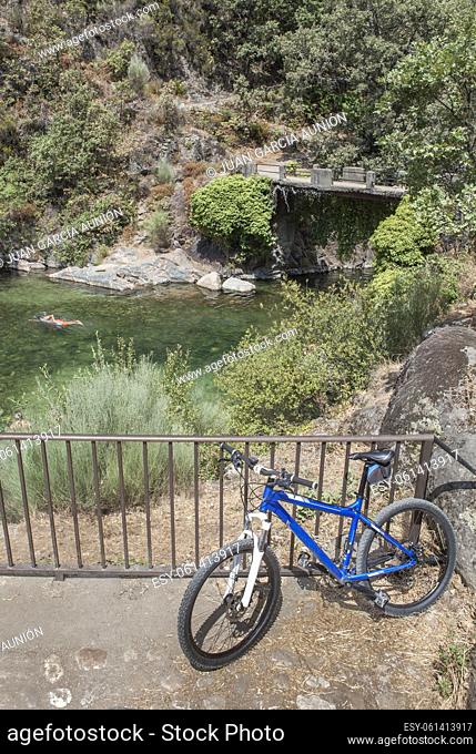 MTB bike parked beside La Maquina Natural swimming pool, Guijo de Santa Barbara, Spain. Great spot for triathlon practitioners
