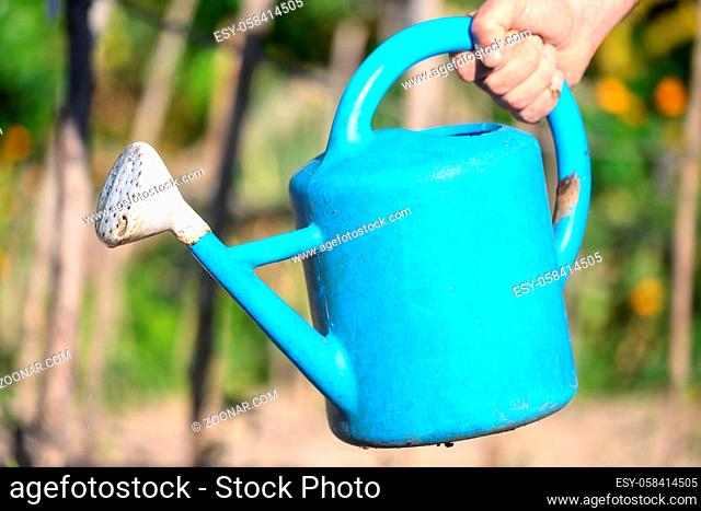 farmer hand holding a watering can. High quality photo