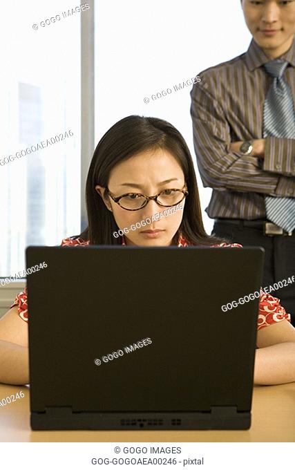 Businesswoman working on laptop in office