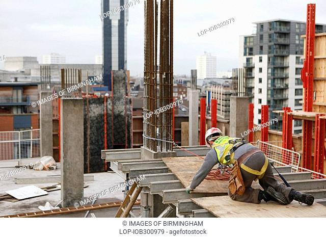 England, West Midlands, Birmingham, A construction worker on The Cube, an innovative and futuristic development in Birmingham city centre where people will be...