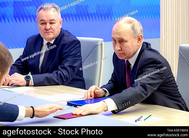 RUSSIA, MOSCOW - DECEMBER 18, 2023: Russia's President Vladimir Putin (R) submits documents to register as a candidate in the upcoming 2024 Russian presidential...