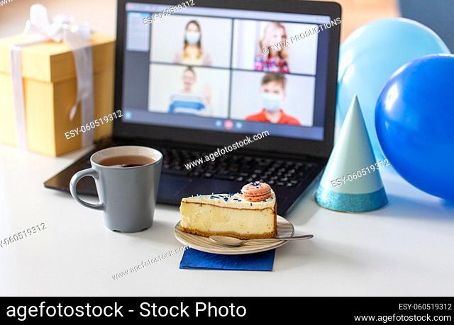 birthday cake and laptop with video call on screen