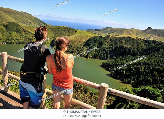 Young couple enjoying the view, Caldeira Funda, Island of Flores, Azores, Portugal