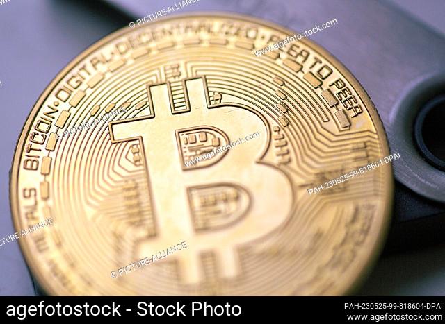 ILLUSTRATION - 22 May 2023, Berlin: A bitcoin coin sits on a Ledger stick, a product of Ledger, a company that provides hardware wallets for cryptocurrencies