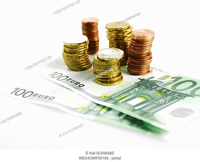 Stack of euro coins and banknotes