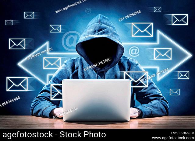 hacker using his computer for spreading spam mails
