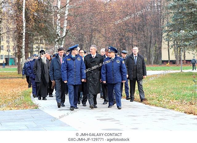 At the Gagarin Cosmonaut Training Center in Star City, Russia, the Expedition 2930 crew members lead a delegation as they walk to their bus Oct