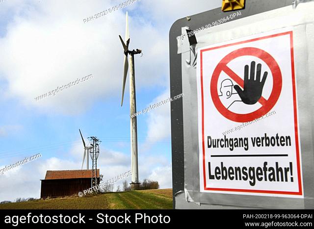 18 February 2020, Hessen, Körle: A warning sign stands in front of the burnt down wind turbine near Körle. Four days after the fire of a wind turbine in...