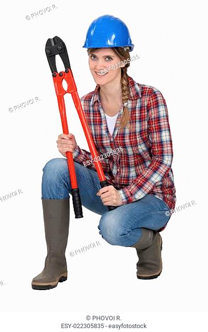 Woman crouching with bolt cutters