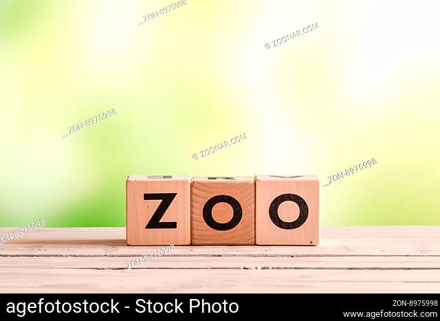 Zoo sign made of wood on a green background
