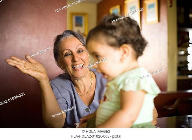 Mature woman smiling at her granddaughter