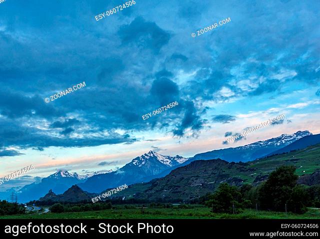 Alps mountain summer morning view with Castles Tourbillon and Montorge and snow covered rocky tops in far, Sion, Switzerland
