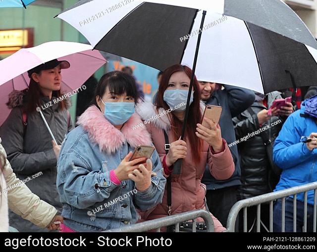 Flushing, Queens, New York, USA, January 25, 2020 - Mask People afraid of the coronavirus During the Queens Lunar New Year Parade in Flushing Along with...