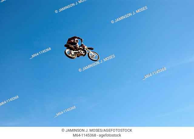 Freestlye motocross rider jumping from a ramp