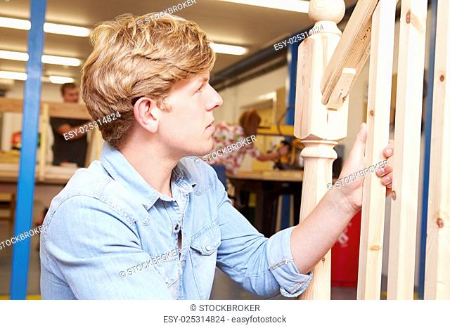 Student In Carpentry Class Working On Staircase