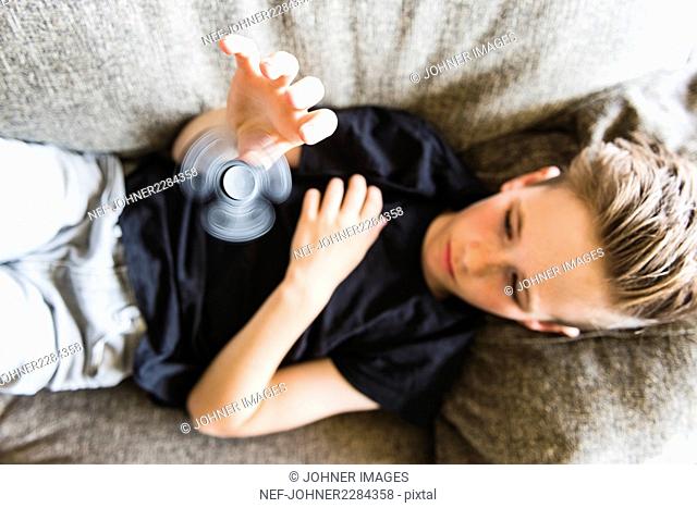 Boy playing with fidget spinner