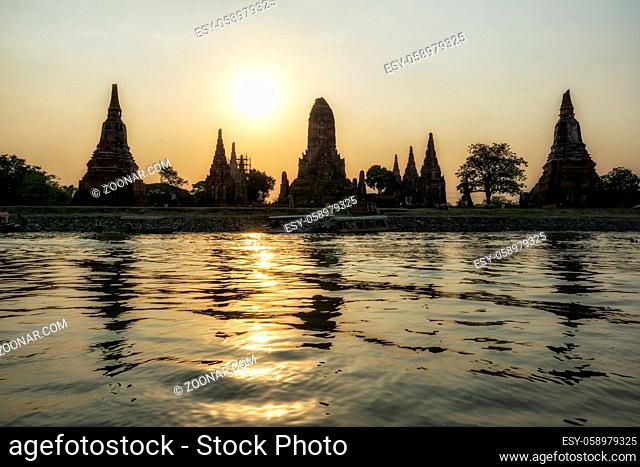 The view of Wat Chaiwatthanaram taken during sunset hours with the reflection on the chao phraya river. Ayutthaya, Thailand